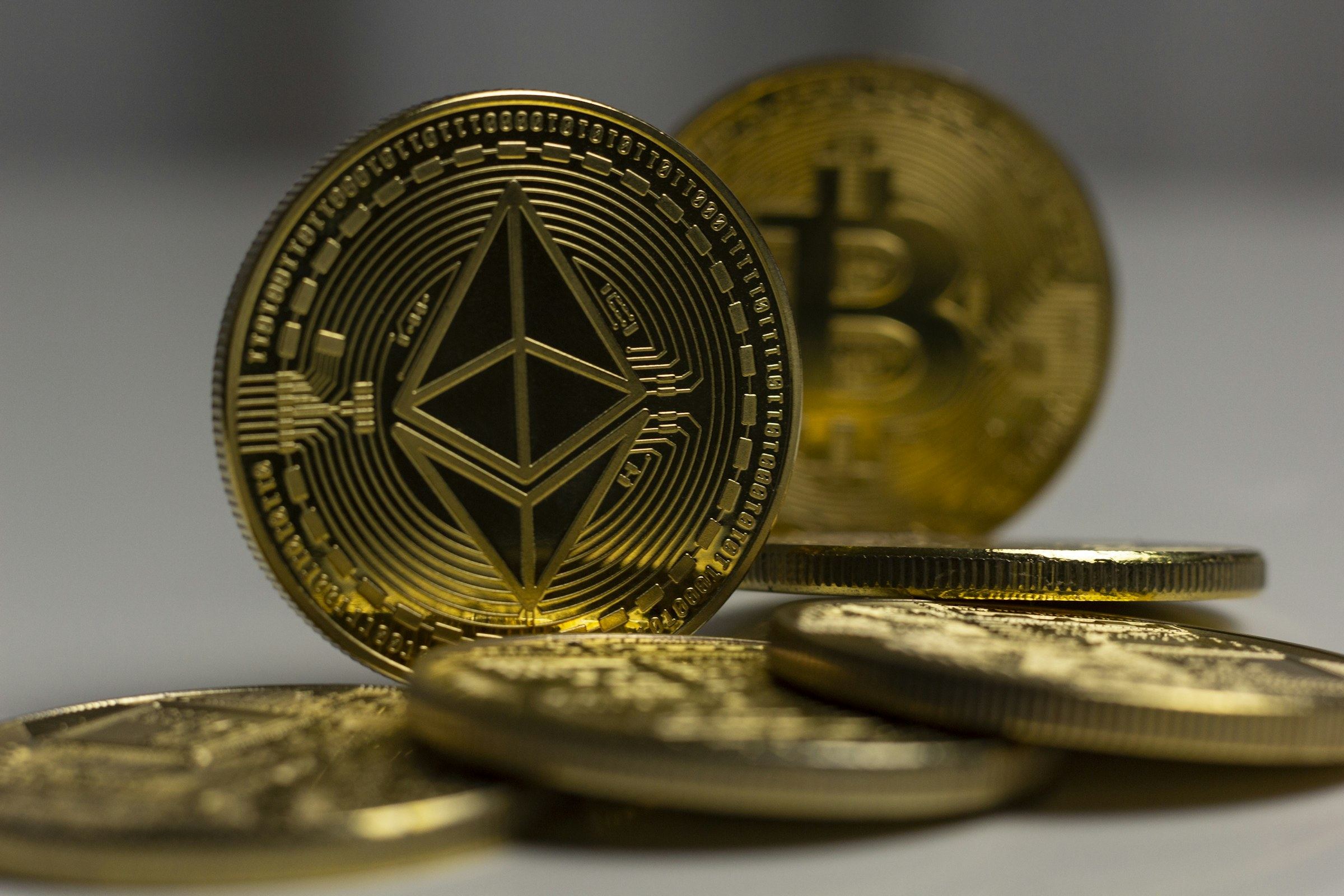 Physical Ethereum and Bitcoin tokens on a desk